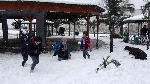 Lapa lapa yağan kar altında çocukların kartopu keyfi