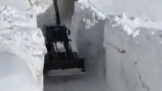 Kar kalınlığının iş makinelerinin boyunu geçtiği yolda zorlu çalışma