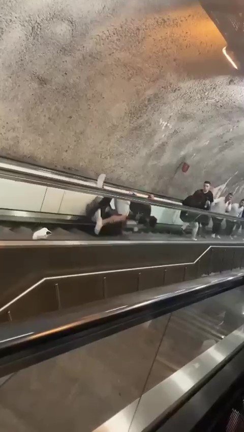 Yürüyen merdivenlerde yuvarlanarak kavga ettiler